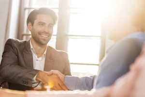 Happy businessman come to an agreement with his colleague.